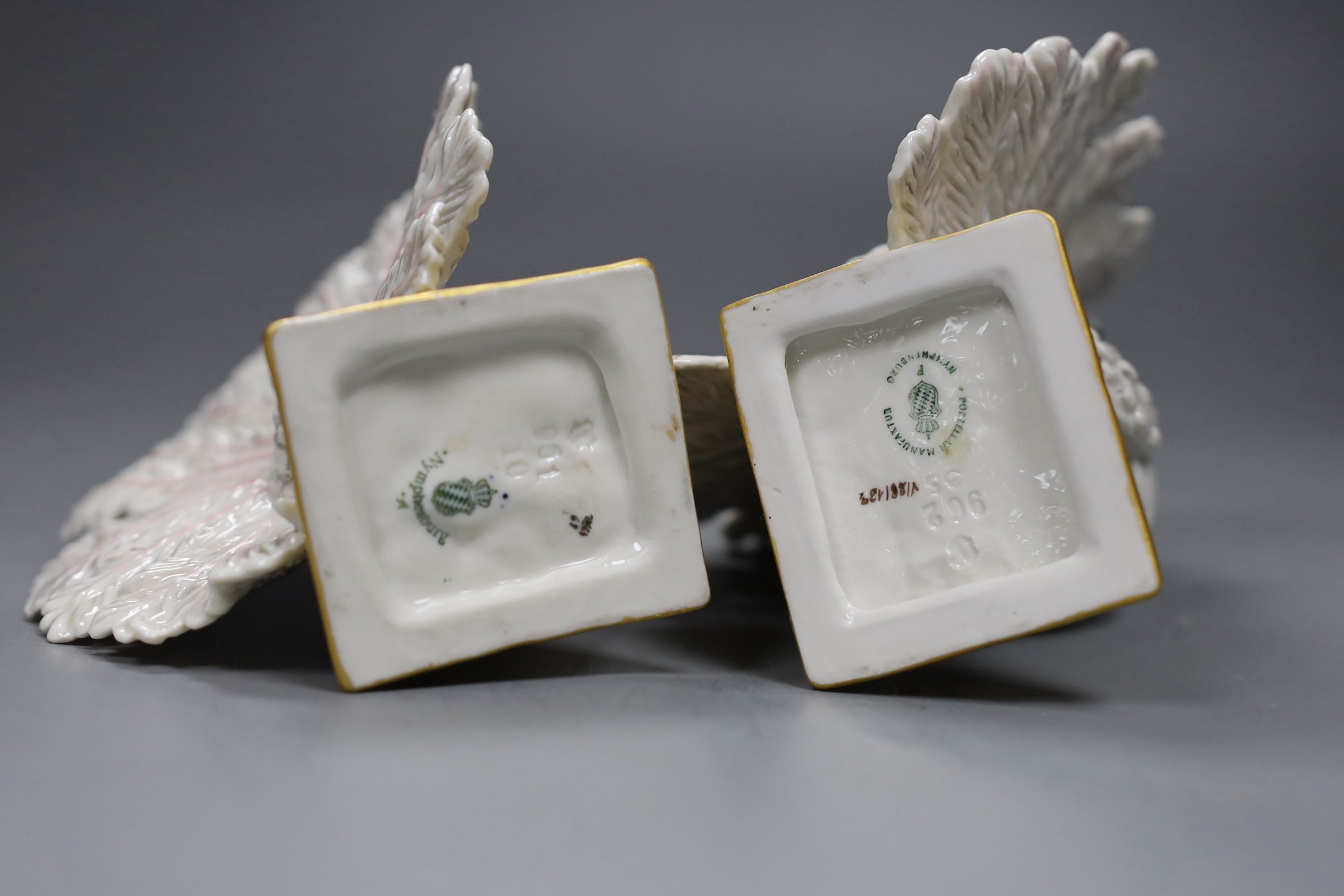 A pair of Nymphenberg porcelain figures of peacock tailed doves, 13cm tall